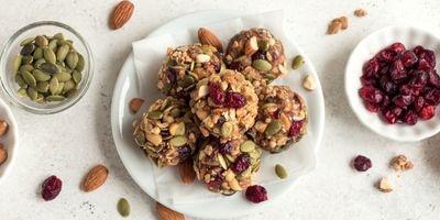 Peanut butter balls garnished with almonds, pepitas and dried cranberries.