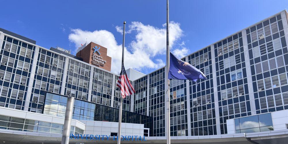 IN MOURNING: Flags in front of Upstate University Hospital fly at half-staff earlier this week in honor of a Syracuse City Police officer and Onondaga County Sheriff Deputy who were killed the line of duty Sunday in Salina.