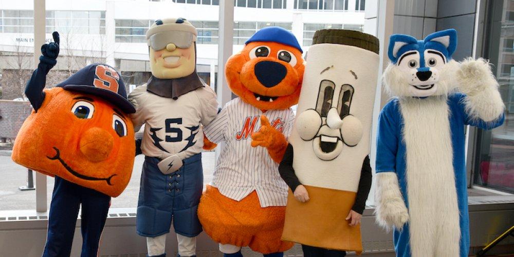 WITH A LITTLE HELP: Area mascots—from Syracuse University, the Syracuse Crunch and the Syracuse Mets—showed up in force April 19 for a campus clean in advance of Earth Day. The group gathered in the Upstate Cancer Center before heading out to clean up campus. From left, are Otto the Orange, Crunchman, Scooch, Mr Butts and Hero from Upstate Medical. 