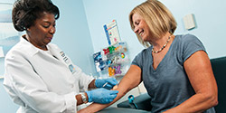 nurse drawing blood from patient